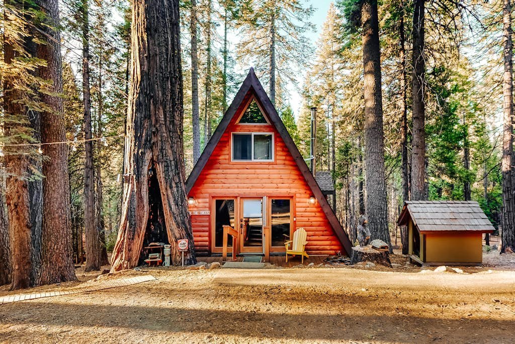 Red A-frame cabin in the forest